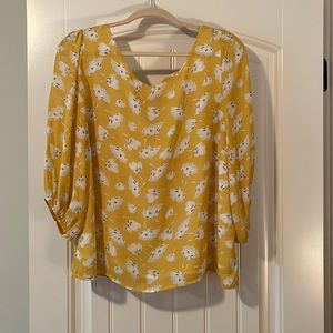 Yellow floral top size large with a open back with bow, and lined